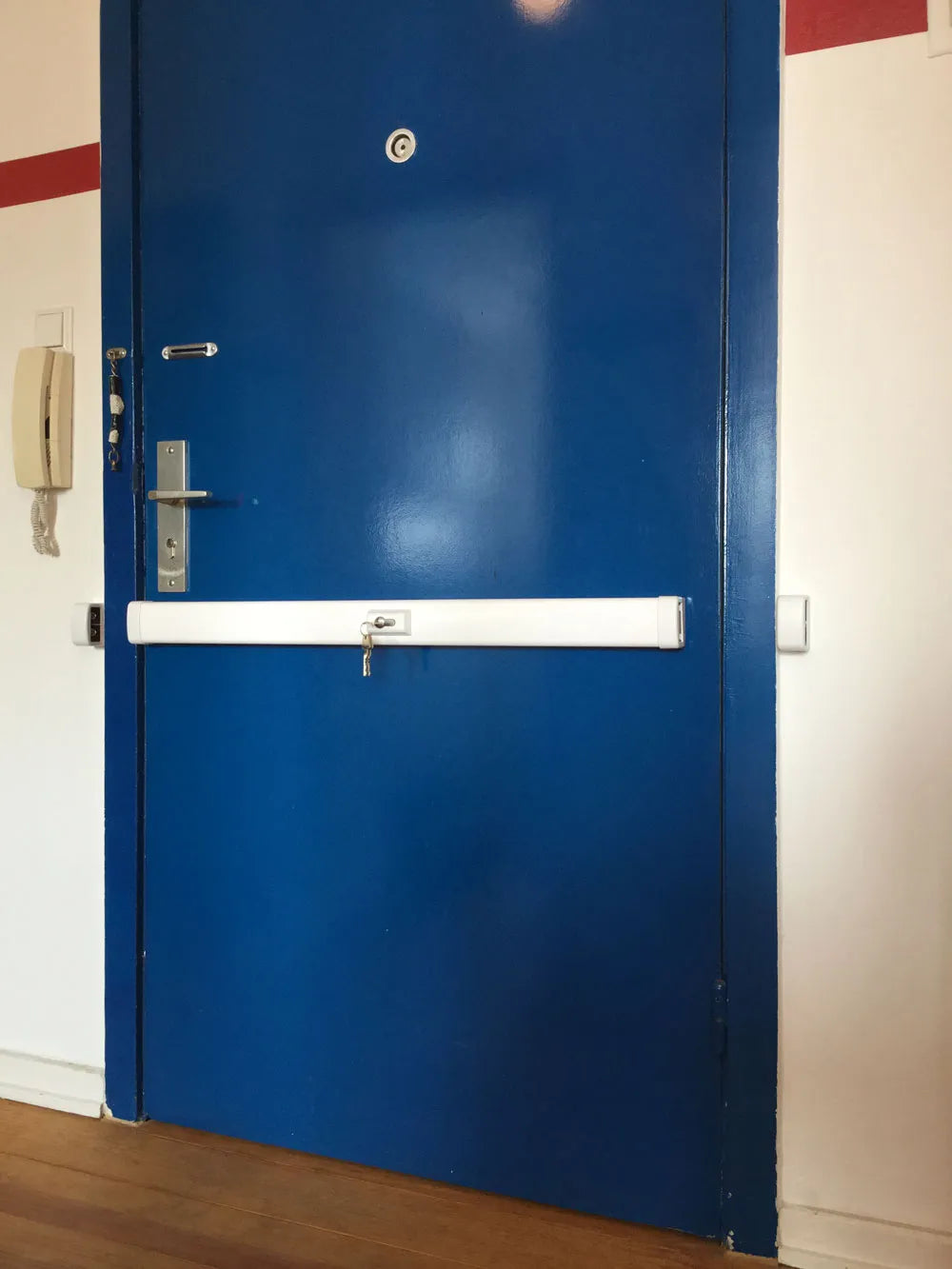 Blaue Wohnungstür mit Querriegel-Türsicherung